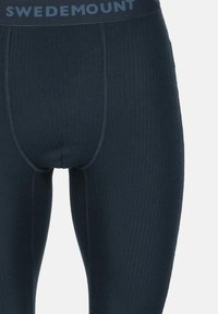Leggings thermiques bleu marine avec une texture côtelée et une taille élastique affichant "SWEDEMOUNT" en bleu clair.