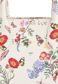 Floral print handbag made of cream faux leather, featuring colorful flowers and butterflies. Notable gold bee accent on the design.