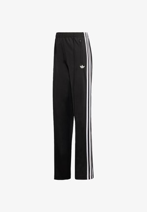 Czarne spodnie dresowe Adidas z elastycznym pasem, białe trzy paski po bokach, kieszeń na zamek oraz biały logo Trefoil na udzie.