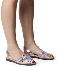 Colorful slingback sandals feature a mesh patterned upper with multicolored details and a metallic rose gold strap and sole. Black rubber outsole.