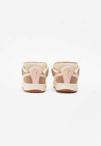 Brown suede sneakers with pink accents, beige details, and a textured white sole; features a logo on the heel and padded collar.