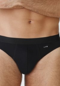 Slip neri da uomo realizzati in tessuto liscio, con una cintura ampia e un logo. Il design è aderente con cuciture rinforzate.