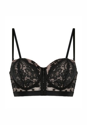 Must mustritud must pitsrinnahoidja, millel on toestavad topsid, läbipaistvad võrkpaneelid ja reguleeritavad rihmad ees oleva sulgemisega.