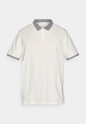 Polo majica, kremne barve, kratki rokavi, ovratnik in manšete s sivo vzorčasto obrobo, dve gumbki spredaj, vezeni logotip na prsih, bombažni material.