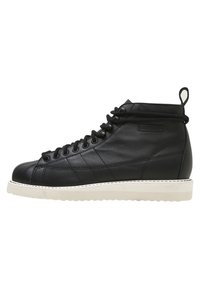 Black leather high-top sneaker with quilted design, round toe, black laces, white rubber sole, and rear tab.
