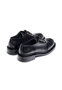 Black leather shoes with a smooth finish, low heel, and rounded toe. Features gold eyelets and black laces, showcasing craftsmanship details.