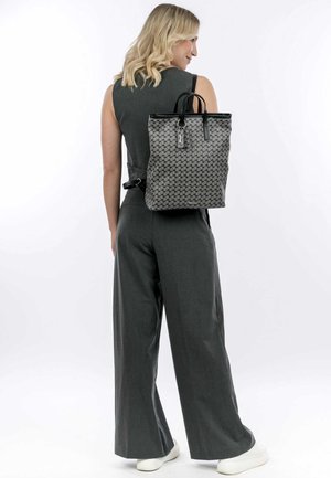 Gray woven fabric backpack with black accents, rectangular shape, top handles, and a sleek zipper closure, seen from the back.