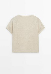 T-shirt beige a maniche corte con scollatura tonda, realizzato in un tessuto leggero e strutturato. Design semplice sul retro, con una vestibilità rilassata e cropped.