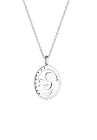 Pendentif en argent sterling avec un design découpé d'une figure, mesurant environ rond, avec de petits accents étincelants d'un côté.