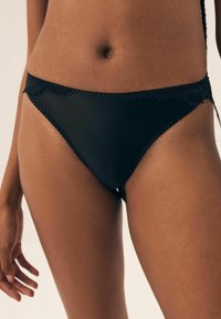 Czarne majtki bikini z gładkiego materiału, z koronkowym wykończeniem przy talii, o niskim kroju i kontrastowych przeszyciach.