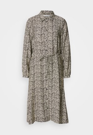 Langärmliges Kleid aus leichtem Stoff. Es hat ein schwarz-weißes Wellenmuster, vordere Knöpfe und eine verstellbare Kordelzug-Taille.