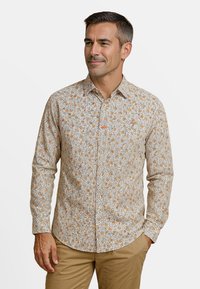 Lichtbeige overhemd met knoopsluiting en een bloemenpatroon in oranje en wit, lange mouwen en een klein borstlogo. Katoenen stof, normale pasvorm.