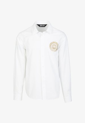 Biała koszula na długi rękaw z guzikami, z beżowym, okrągłym logo tygrysa na lewej piersi oraz metką "Just Cavalli" wewnątrz kołnierza.