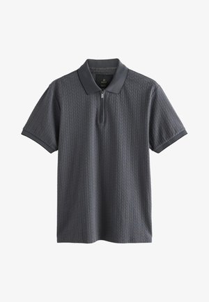 Polo gris à manches courtes avec col zippé, motif en losanges texturé et col contrastant. Confectionné dans un tissu doux et respirant.