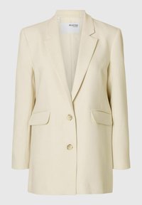 Beige skræddersyet blazer med spids klaffepude, dobbelt knaplukning og to forlommer. Glat, struktureret stof.