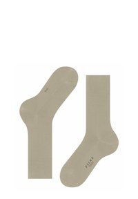 Calzini di cotone beige con una texture liscia, dotati di punta e tallone rinforzati e con un polsino moderatamente a coste. Contrassegnati dal marchio "Falke Tiago".