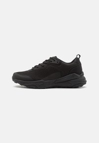 Black athletic shoes featuring a mesh upper, textured panel accents, and a sturdy rubber sole with a pull tab at the heel.