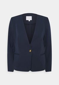 Blazer marine avec un décolleté en V peu profond, fermeture à un bouton doré, deux poches avant et texture de tissu lisse. Pas de doublure visible.