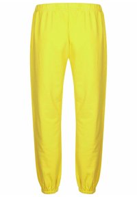 Gele joggingsbroek met een elastische tailleband en boorden, gemaakt van zacht katoenmateriaal. Eenvoudig ontwerp, rechte pijpen, geen patronen of accenten.