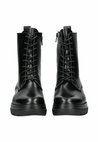 Bottes noires en cuir avec un laçage à l'avant et une fermeture éclair latérale, dotées d'une semelle en caoutchouc épaisse et d'une finition lisse et brillante.