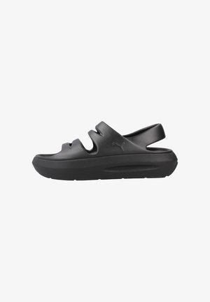 Sandalias tipo chancla negras con punta redondeada, diseño con recortes y suela acolchada. Fabricadas con material resistente y estilo minimalista.