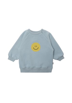 Light blue sweatshirt made of soft fabric, featuring a round yellow smiley face graphic on the center front and ribbed cuffs.