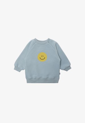 Light blue sweatshirt made of soft fabric, featuring a round yellow smiley face graphic on the center front and ribbed cuffs.