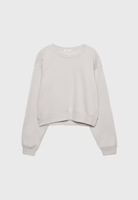 Sweat-shirt court beige clair à manches longues, col rond, avec poignets et ourlet côtelés sur un fond uni.