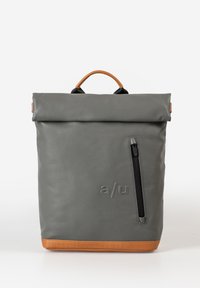 Gray roll-top backpack made of durable material with a brown leather bottom, features a side zipper pocket and a top handle for carrying.