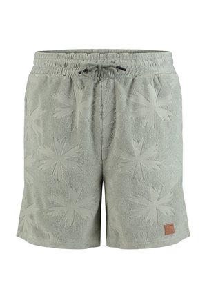 Jasnozielone szorty z frotté z elastycznym pasem, sznurkiem do ściągania i tłoczonymi wzorami w kształcie gwiazdek.