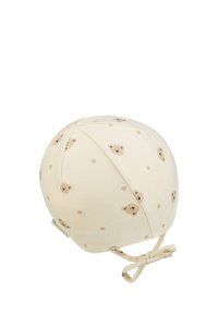 Cream baby bonnet with small teddy bear faces and dots pattern, tied under the chin with a bow.