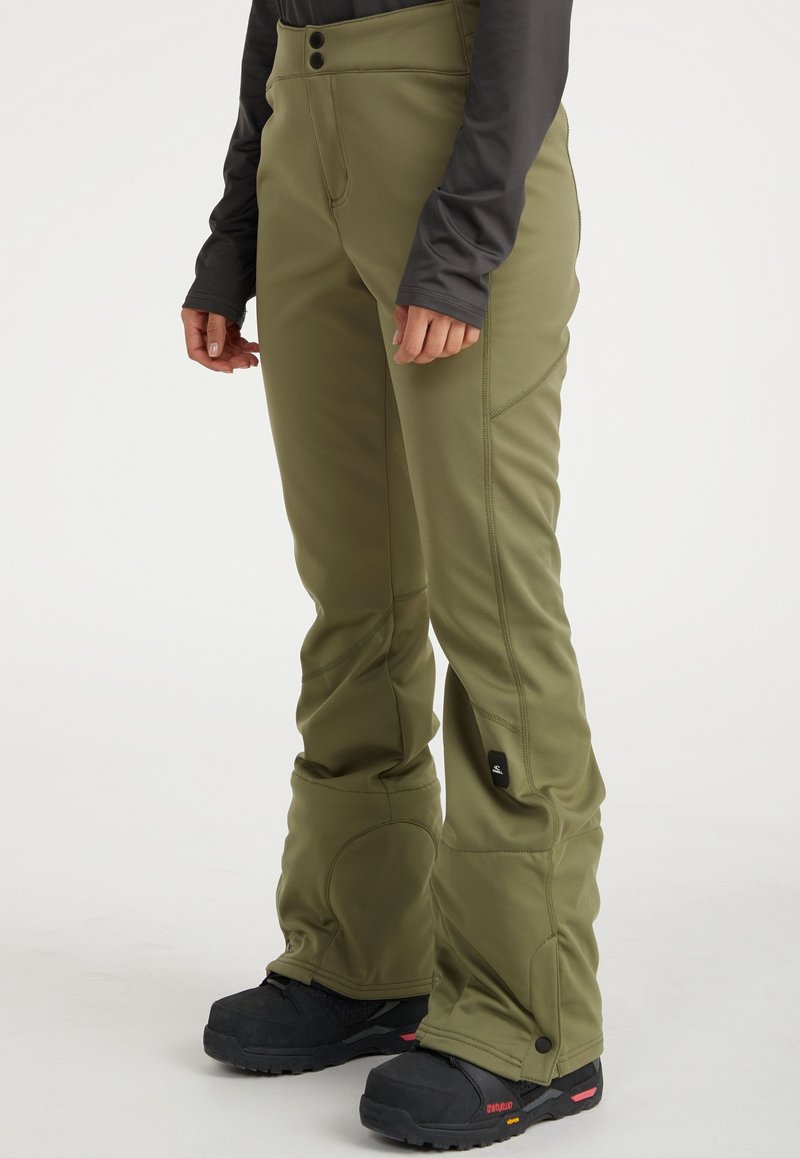 Olivgrüne Skihosen mit taillierter Passform, zwei Knopfverschlüssen, verstärkten Nähten und seitlichen Belüftungen. Kombiniert mit schwarzem Schuhwerk für einen Kontrast.
