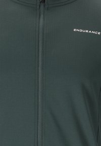 Dark green long-sleeve athletic top featuring a textured fabric, full front zipper, and a white "ENDURANCE" logo on the chest.