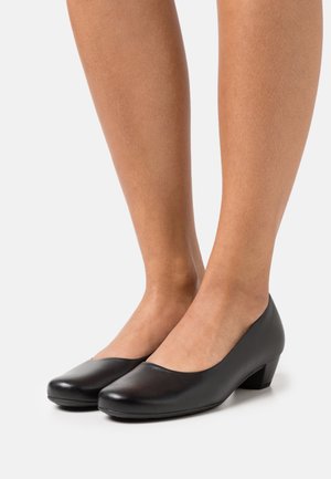 Black leather low-heeled shoes with a rounded toe and slight sheen. The design features a smooth finish and a minimalist silhouette.