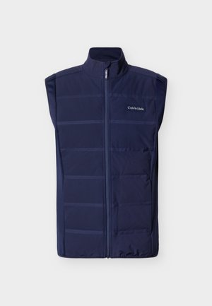 Marineblå ermeløs vattert vest med frontglidelås og Calvin Klein-logo på brystet, høy krage og quiltede horisontale linjer.