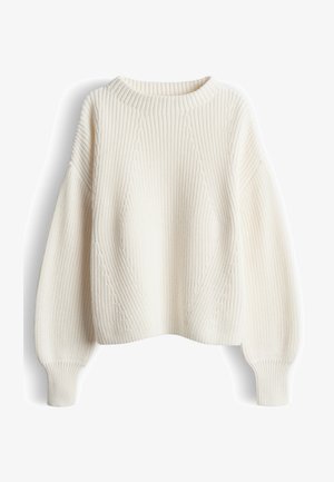 Pull en maille couleur crème présentant un motif côtelé texturé, épaules tombantes et larges poignets côtelés. Silhouette volumineuse et surdimensionnée.