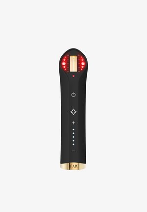 Black ergonomic device with a rounded top, featuring red indicator lights, gold accents, and control buttons along a textured handle.