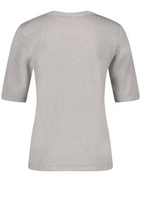 Světlě šedý svetřík s krátkými rukávy, kulatým výstřihem, hladkým povrchem a jednoduchým designem bez viditelných vzorů nebo kovových akcentů.