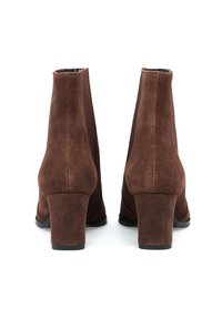 Brązowe zamszowe botki za kostkę na słupku, z elastycznymi bokami dla łatwego zakładania i gładką czarną podeszwą.