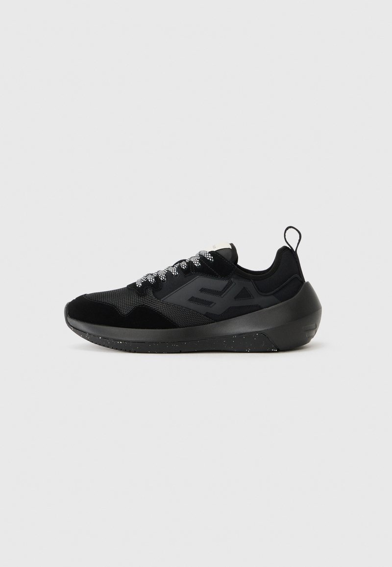 Black athletic sneaker with a mesh and suede upper, textured laces, bold logo detail, and a solid rubber sole featuring speckled accents.