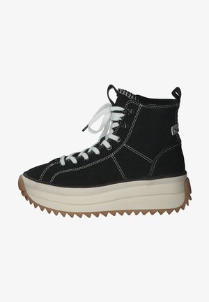 Black canvas high-top shoes with white laces, thick cream sole, and gum rubber grip. Features contrast stitching and a pull tab on the back.
