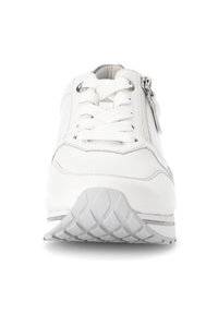Witte sneaker met een gladde leren bovenkant, metalen ogen, platte veters en een zijrits. Geribbelde rubberen zool voor grip.