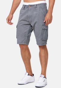 Grå bomulds cargo shorts med flere sidelommer, knaplukning og moderne pasform. Har en let falmet tekstur og syede detaljer.