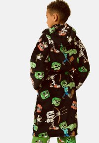 Schwarzer Kapuzenfleece-Mantel mit bunten Cartoon-Charakteren, darunter Blöcke und Skelette, mit einer weichen, strukturierten Oberfläche.