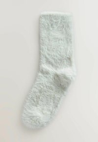 Donkergroene, lichtgroene sok gemaakt van een zacht, gestructureerd materiaal. Voorzien van een geribde boord en een gladde binnenkant. Geschikt voor dagelijks gebruik.