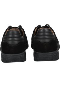 Black suede sneakers with a smooth leather heel, textured rubber sole, and a padded collar. Features contrasting stitching accents.