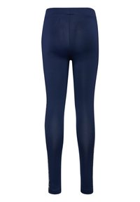 Marinblå leggings med en slät yta, figursydd design och hög midja. Har dekorativa blommönster längs sidorna.