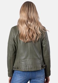 Olive green leather motorcycle jacket with ribbed shoulder accents, fitted silhouette, and silver hardware details on the back.
