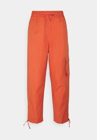 Oranga cargobyxor med elastisk midjeband och dragsko. Har en sidoficka och justerbara benöppningar. Slät textur.