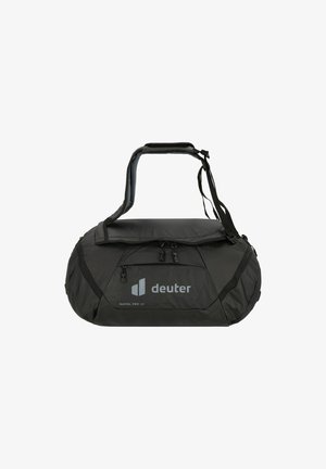 Bolsa de deporte negra con forma redondeada, hecha de material duradero. Cuenta con un bolsillo frontal con cremallera, asa superior y correa de hombro ajustable.